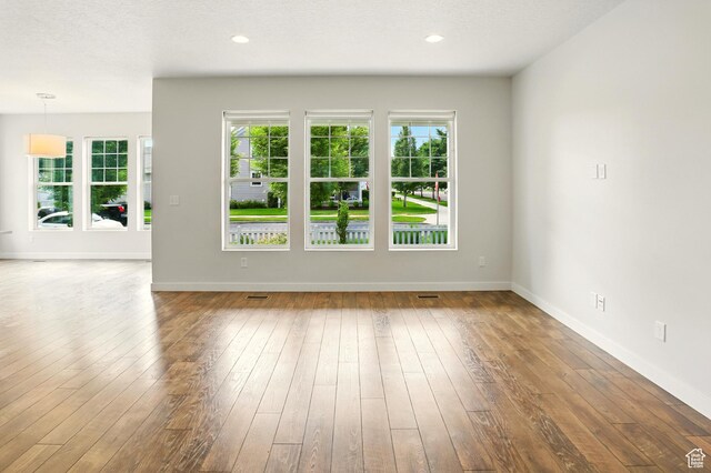 5254 W Burntside Ave, South Jordan, UT 84009 - unfurnished living room with wood-type flooring and baseboards