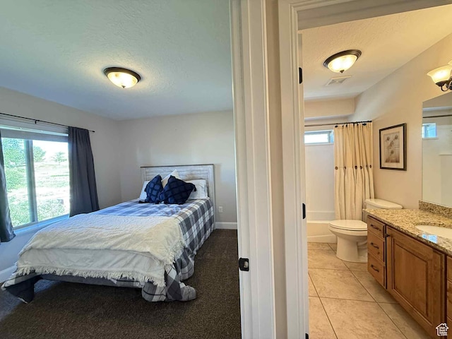 420 N Josephine Ln, Price, UT 84501 - bedroom with a textured ceiling, light tile patterned flooring, and ensuite bath