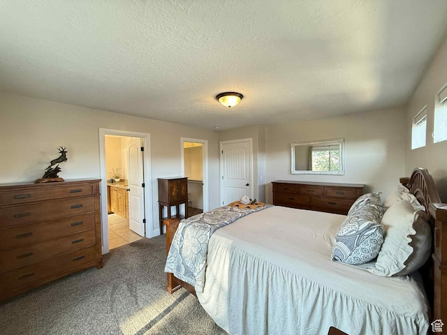 420 N Josephine Ln, Price, UT 84501 - bedroom with light colored carpet, a textured ceiling, and connected bathroom