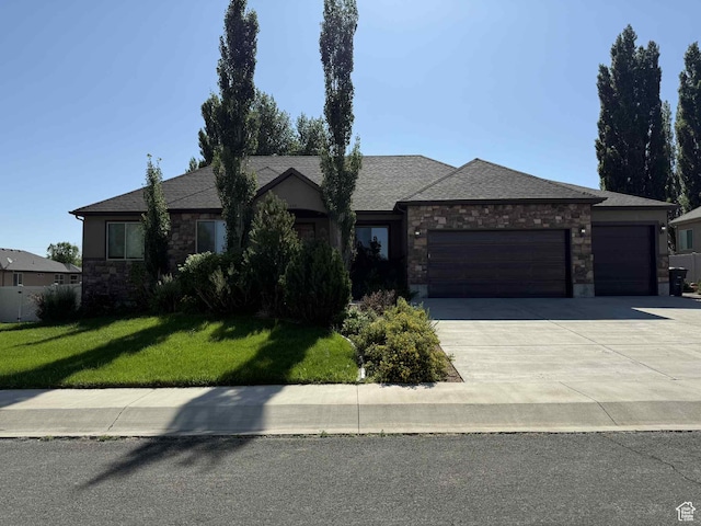 420 N Josephine Ln, Price, UT 84501 - view of front of house with stone siding, an attached garage, a front yard, concrete driveway, and a shingled roof