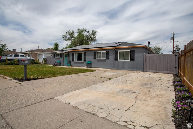 4586 W 4925 S, Kearns, UT 84118 - view of front facade with solar panels, driveway, and a gate