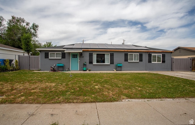 4586 W 4925 S, Kearns, UT 84118 - view of front of home featuring a gate and roof mounted solar panels