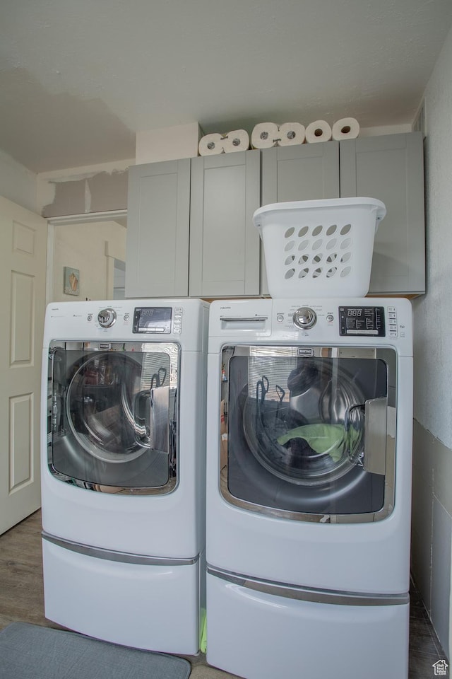4586 W 4925 S, Kearns, UT 84118 - laundry area featuring cabinet space, washer and dryer, and wood finished floors