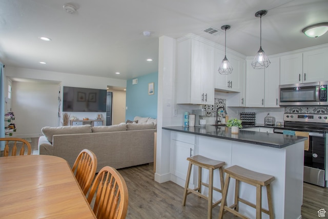 4586 W 4925 S, Kearns, UT 84118 - kitchen with stainless steel appliances, dark countertops, white cabinetry, and recessed lighting