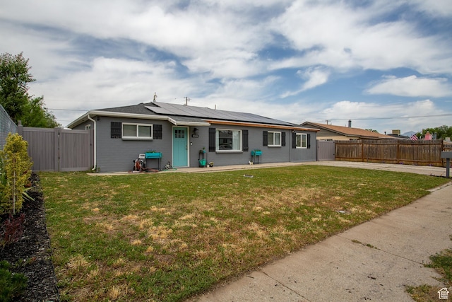 4586 W 4925 S, Kearns, UT 84118 - back of house featuring a gate, roof mounted solar panels, a fenced backyard, and brick siding