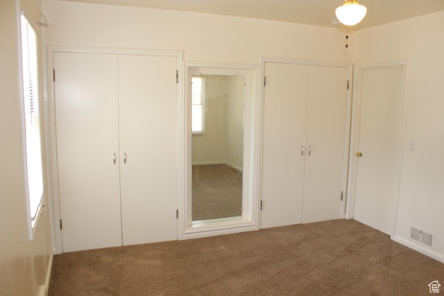 2342 S Van Buren Ave E, Ogden, UT 84403 - unfurnished bedroom with multiple closets and carpet