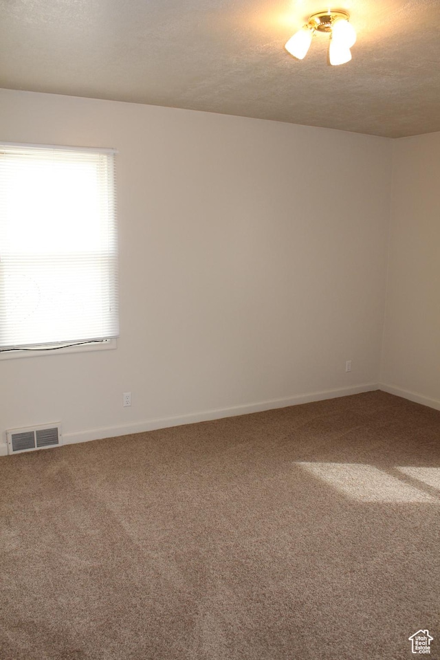 2342 S Van Buren Ave E, Ogden, UT 84403 - carpeted empty room with baseboards and a textured ceiling