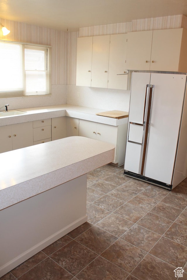 2342 S Van Buren Ave E, Ogden, UT 84403 - kitchen featuring freestanding refrigerator and light countertops