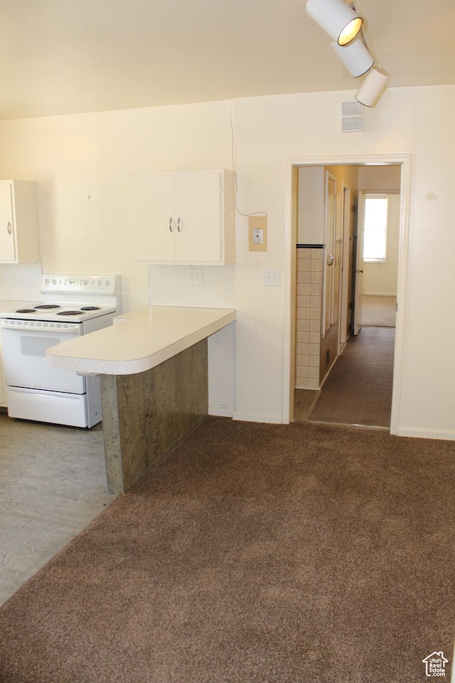 2342 S Van Buren Ave E, Ogden, UT 84403 - kitchen featuring electric stove, white cabinetry, light countertops, carpet flooring, and a peninsula