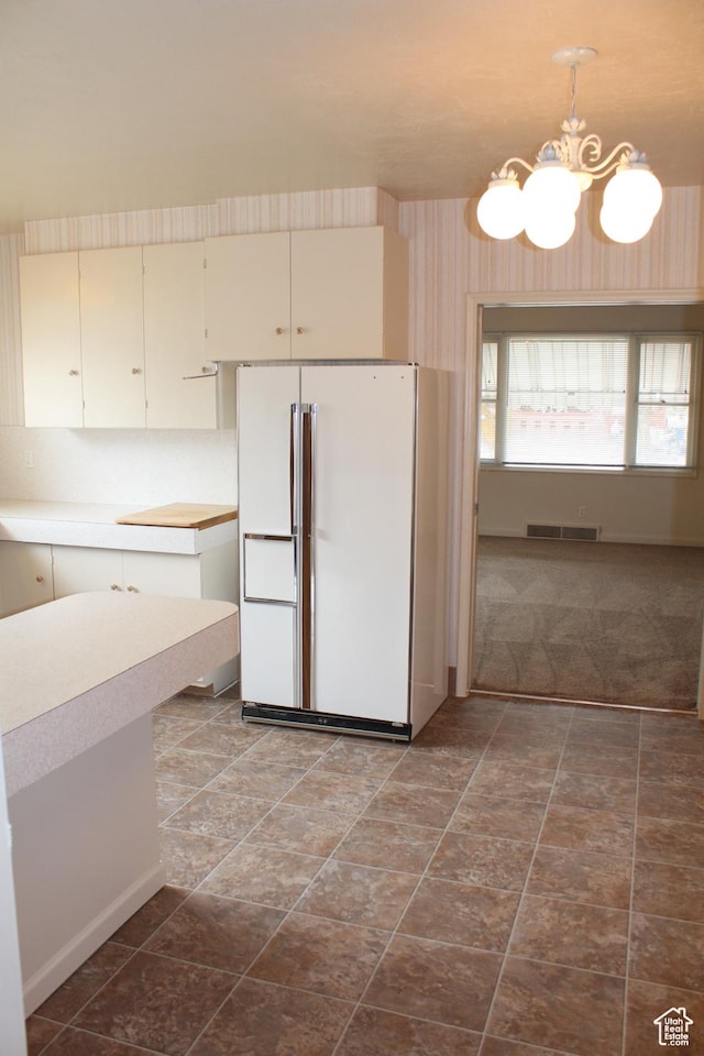 2342 S Van Buren Ave E, Ogden, UT 84403 - kitchen with freestanding refrigerator, a chandelier, light countertops, and hanging light fixtures