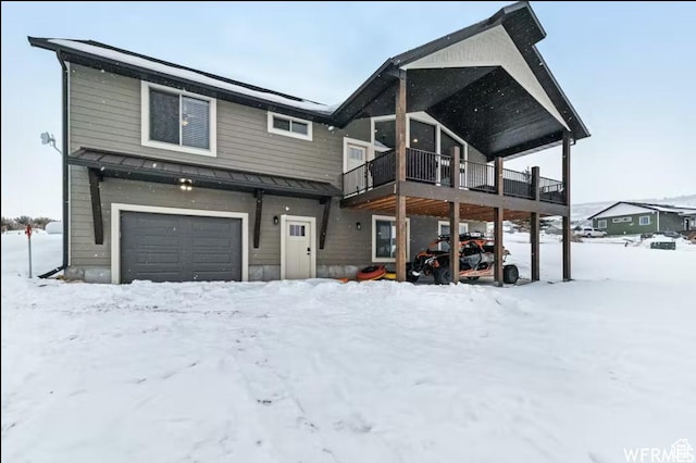 2915 S Golf Course Dr, Garden City, UT 84028 - view of front of home with an attached garage, a standing seam roof, and a wooden deck