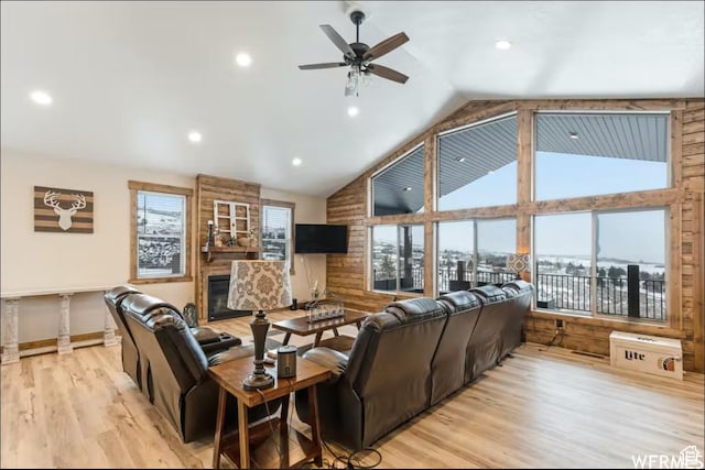 2915 S Golf Course Dr, Garden City, UT 84028 - living area with light wood finished floors, ceiling fan, high vaulted ceiling, recessed lighting, and a glass covered fireplace