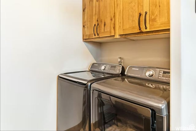 2915 S Golf Course Dr, Garden City, UT 84028 - laundry room featuring separate washer and dryer and cabinet space