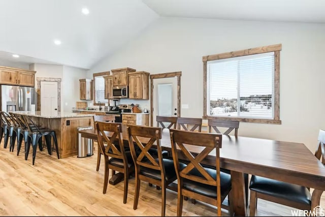 2915 S Golf Course Dr, Garden City, UT 84028 - dining space featuring vaulted ceiling, healthy amount of natural light, and light wood-type flooring