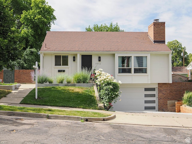 2512 E Redondo Ave S, Salt Lake City, UT 84108 - view of front of property featuring a chimney, an attached garage, and driveway