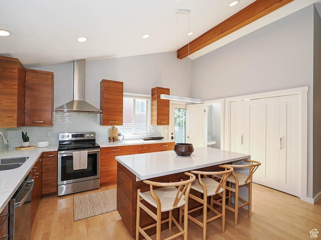 2512 E Redondo Ave S, Salt Lake City, UT 84108 - kitchen featuring wall chimney range hood, stainless steel appliances, modern cabinets, brown cabinetry, and recessed lighting