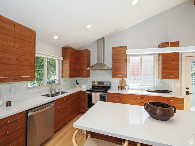 2512 E Redondo Ave S, Salt Lake City, UT 84108 - kitchen featuring appliances with stainless steel finishes, wall chimney range hood, lofted ceiling, modern cabinets, and tasteful backsplash