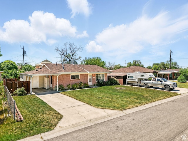 3340 S 2000 W, West Valley City, UT 84119 - ranch-style house featuring driveway, a carport, and brick siding