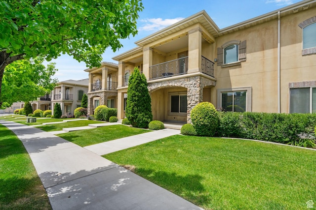 998 W 950 N, Orem, UT 84057 - view of front of property with stucco siding, a front lawn, a balcony, and stone siding