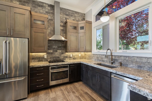 11989 S 3600 W, Riverton, UT 84065 - kitchen featuring appliances with stainless steel finishes, wall chimney range hood, ornamental molding, light wood-style flooring, and tasteful backsplash