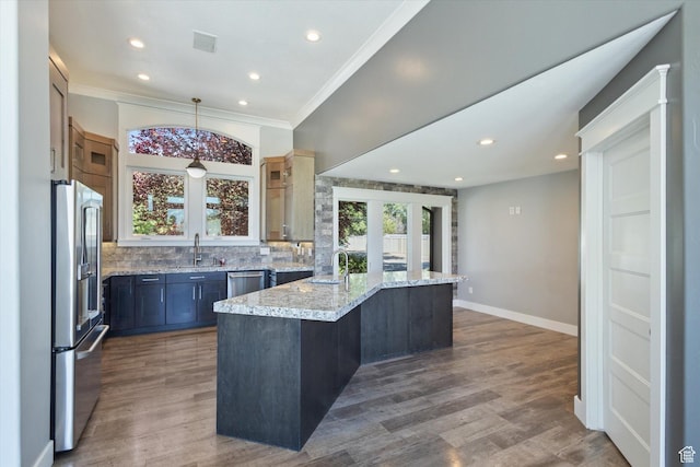11989 S 3600 W, Riverton, UT 84065 - kitchen featuring stainless steel appliances, backsplash, wood finished floors, light stone countertops, and crown molding