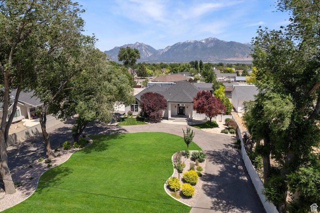 11989 S 3600 W, Riverton, UT 84065 - view of front of home featuring a mountain view, curved driveway, and a front yard