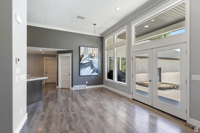 11989 S 3600 W, Riverton, UT 84065 - unfurnished dining area with plenty of natural light, wood finished floors, crown molding, french doors, and recessed lighting