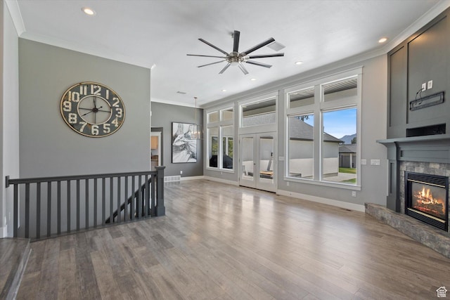 11989 S 3600 W, Riverton, UT 84065 - unfurnished living room with ornamental molding, a glass covered fireplace, ceiling fan, wood finished floors, and recessed lighting