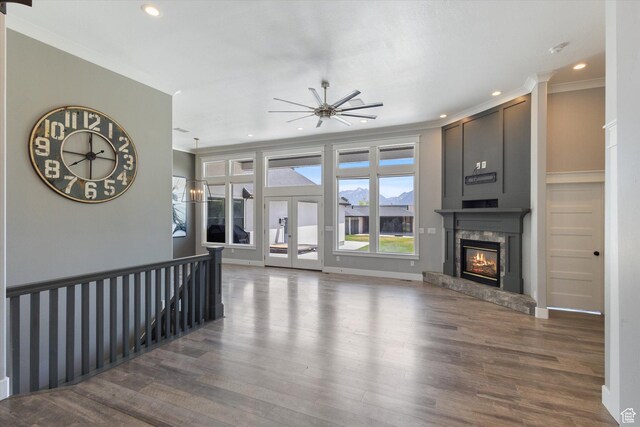 11989 S 3600 W, Riverton, UT 84065 - unfurnished living room featuring a fireplace, wood finished floors, recessed lighting, crown molding, and a ceiling fan