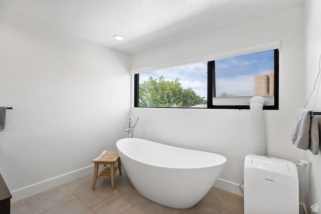 615 E 100 S Unit 1, Salt Lake City, UT 84102 - full bath with a freestanding bath, a textured ceiling, and tile patterned flooring