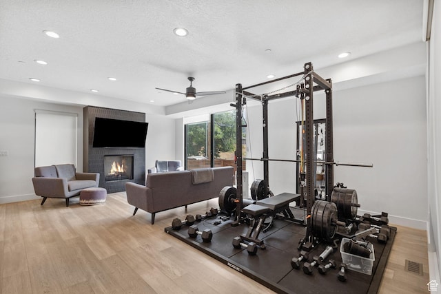 615 E 100 S Unit 1, Salt Lake City, UT 84102 - exercise area featuring a fireplace, recessed lighting, light wood-style floors, and ceiling fan