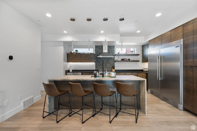 615 E 100 S Unit 1, Salt Lake City, UT 84102 - kitchen featuring stainless steel built in fridge, wall chimney range hood, open shelves, a kitchen bar, and recessed lighting
