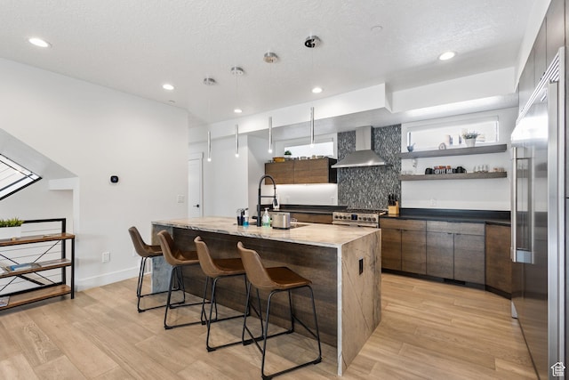 615 E 100 S Unit 1, Salt Lake City, UT 84102 - kitchen with wall chimney range hood, modern cabinets, premium appliances, light wood-style floors, and recessed lighting
