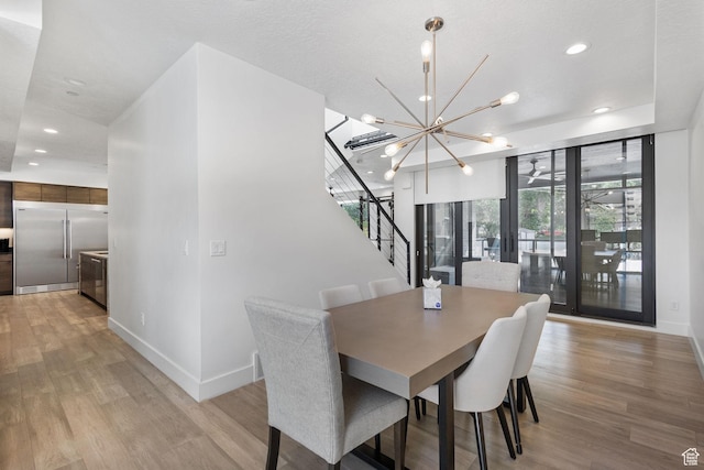 615 E 100 S Unit 1, Salt Lake City, UT 84102 - dining room with stairway, a chandelier, light wood-style flooring, and recessed lighting
