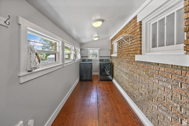 331 Chateau Thierry St, Soda Springs, ID 83276 - hall featuring washing machine and clothes dryer, dark wood-style floors, brick wall, and vaulted ceiling