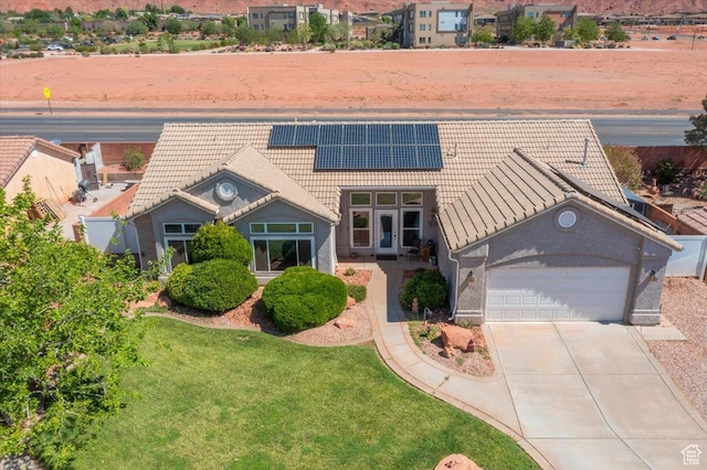 329 E 20 S, Ivins, UT 84738 - view of front of home featuring a tiled roof, an attached garage, solar panels, driveway, and a front yard