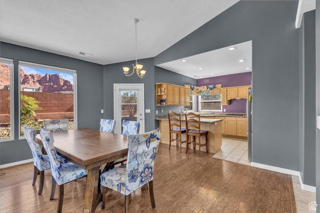 329 E 20 S, Ivins, UT 84738 - dining room featuring a chandelier, healthy amount of natural light, light wood-style flooring, and lofted ceiling