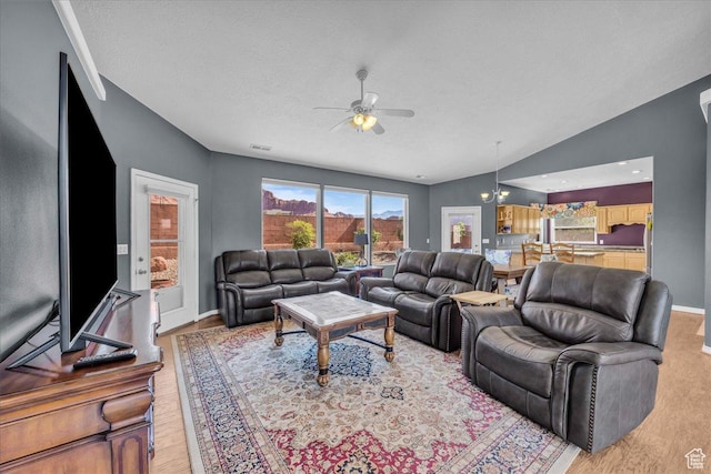 329 E 20 S, Ivins, UT 84738 - living area featuring light wood-style floors, ceiling fan, lofted ceiling, and a textured ceiling