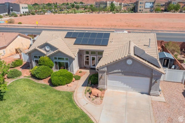 329 E 20 S, Ivins, UT 84738 - view of front of home with a tiled roof, a garage, concrete driveway, solar panels, and stucco siding