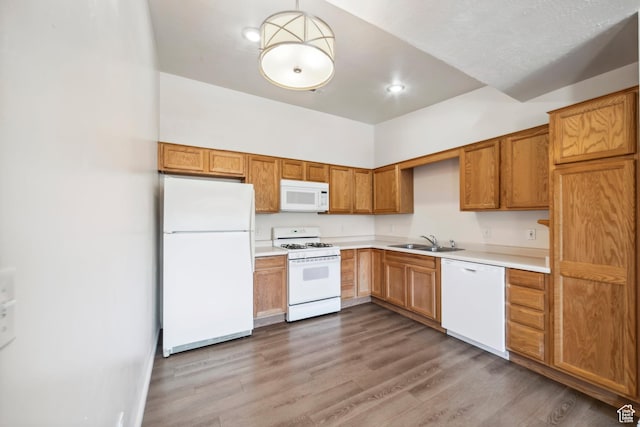 35 E 600 S Unit B202, Ivins, UT 84738 - kitchen featuring white appliances, light countertops, wood finished floors, brown cabinets, and recessed lighting