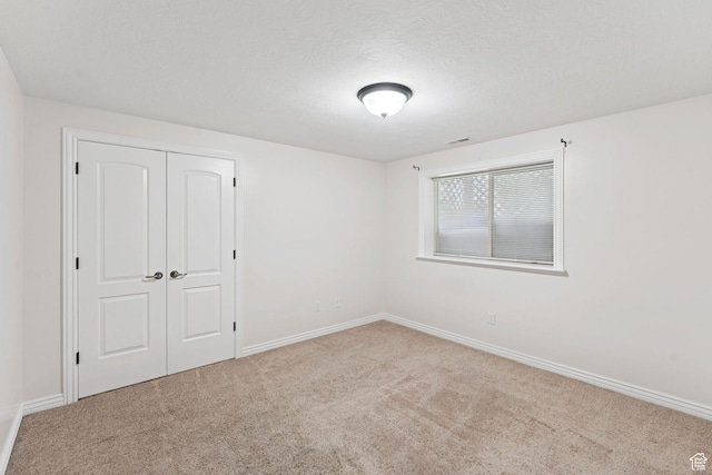 2828 W Gentile St, Layton, UT 84041 - unfurnished bedroom with carpet flooring, a closet, and a textured ceiling