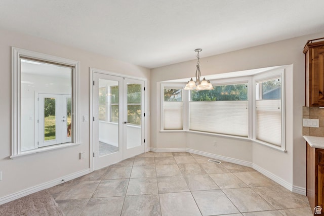 2828 W Gentile St, Layton, UT 84041 - unfurnished dining area featuring a chandelier, french doors, and light tile patterned floors