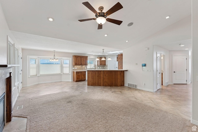 2828 W Gentile St, Layton, UT 84041 - unfurnished living room featuring a high end fireplace, a chandelier, light tile patterned flooring, recessed lighting, and a ceiling fan