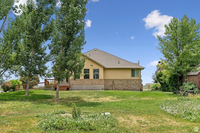2828 W Gentile St, Layton, UT 84041 - back of house featuring a deck, a lawn, stucco siding, and brick siding