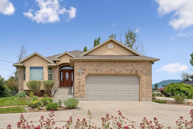 2828 W Gentile St, Layton, UT 84041 - ranch-style house with driveway, an attached garage, stucco siding, and brick siding