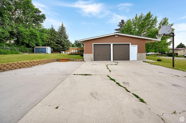 421 S 90 W, Richmond, UT 84333 - garage featuring concrete driveway and a storage unit