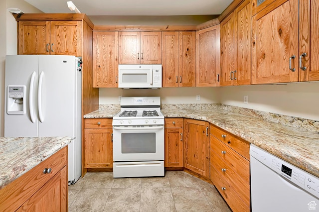 421 S 90 W, Richmond, UT 84333 - kitchen with white appliances, light stone counters, and brown cabinetry