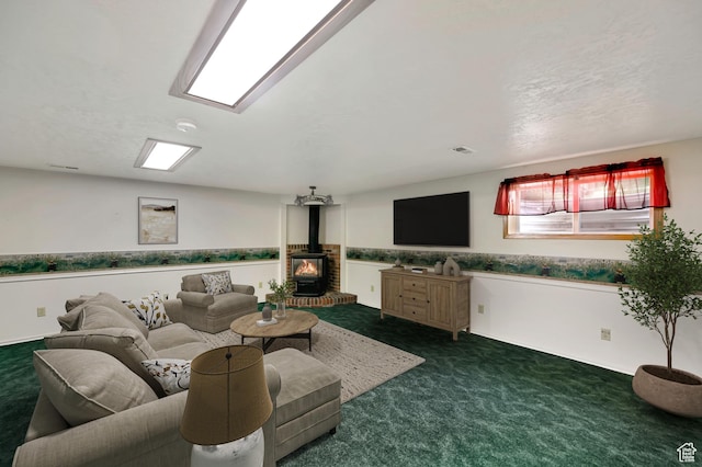 421 S 90 W, Richmond, UT 84333 - living room featuring dark carpet and a wood stove