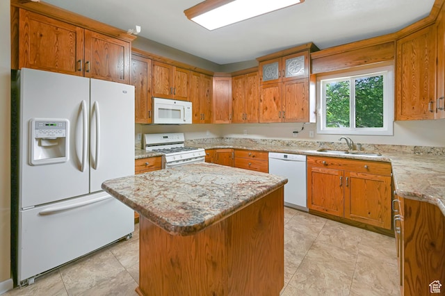 421 S 90 W, Richmond, UT 84333 - kitchen featuring white appliances, a kitchen island, and brown cabinets