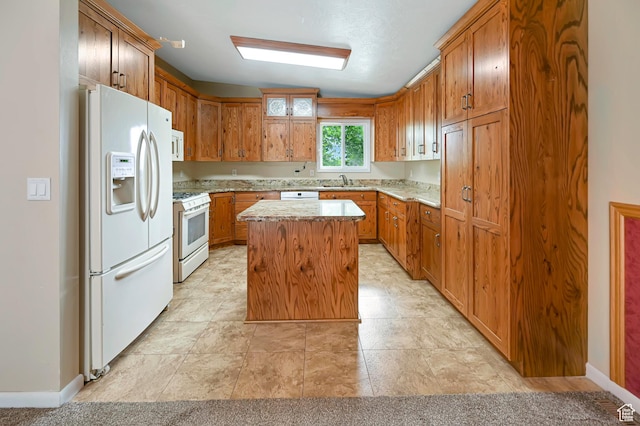 421 S 90 W, Richmond, UT 84333 - kitchen with white appliances, a kitchen island, brown cabinets, and light stone countertops